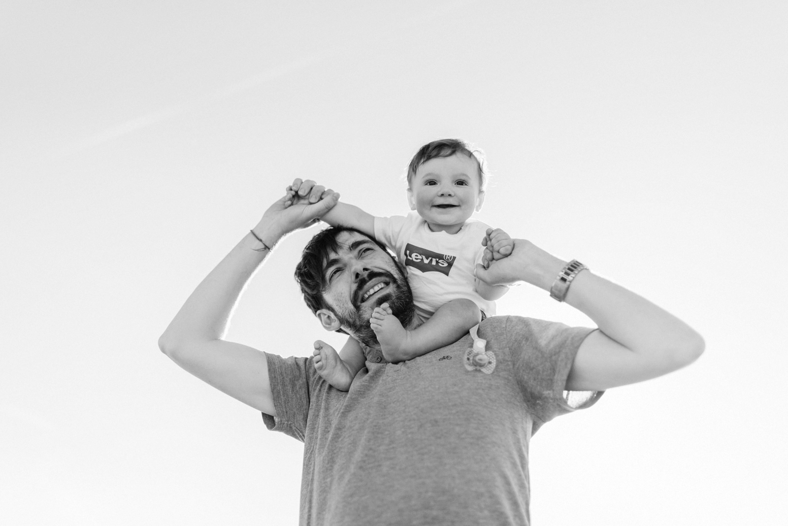 Un padre disfrutando con su hijo en una sesión de fotos de familia al atardecer